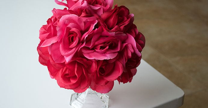 diy center pieces with fake flowers in styrofoam balls. Glue it to a vase!