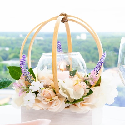 Wedding centerpiece with craft hoops, faux floral, and a glass round vase