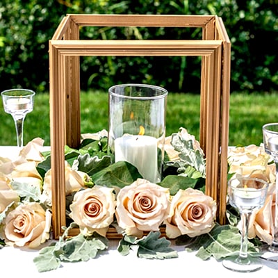 Photo frame “lantern” with candle in center surrounded by pink roses
