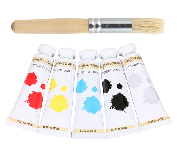 Stenciling paint brush and tubes of watercolor paints