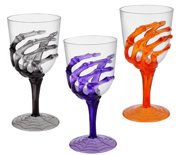 Wine glasses being held by colorful skeleton hands