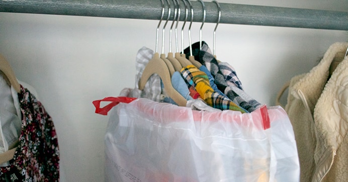 An easy way to move the clothes in your closet: wrap a trash bag